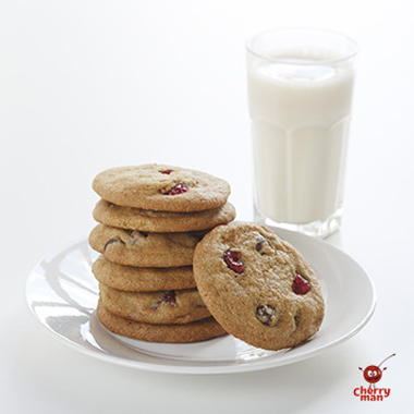 A stack of chocolate cherry cookies served with cold milk. 